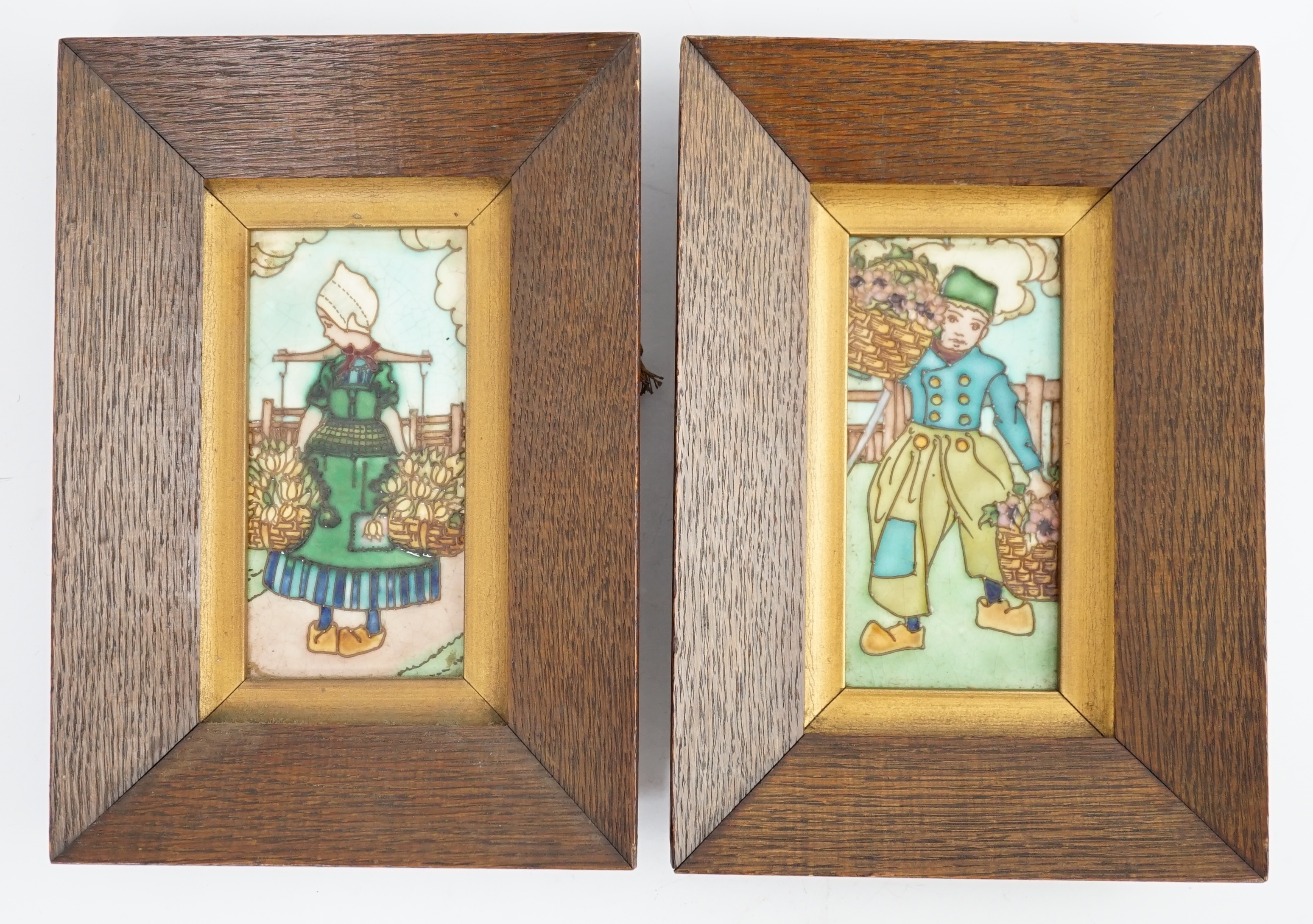 A pair of Charlotte Rhead 'Dutch' tiles, decorated with children carrying baskets of flowers